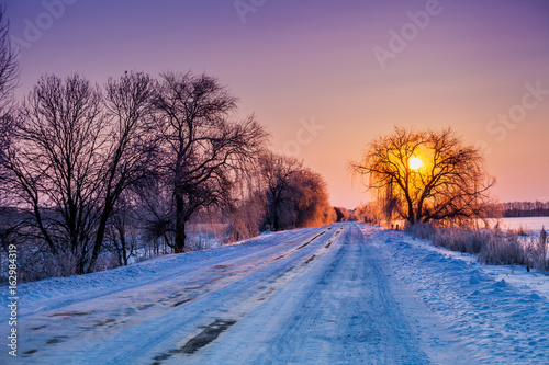 Early morning, road covered with snow at sunrise © vvvita