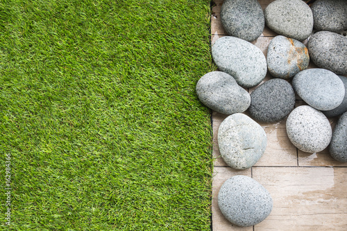 Artificial grass on balcony floor with pebbles