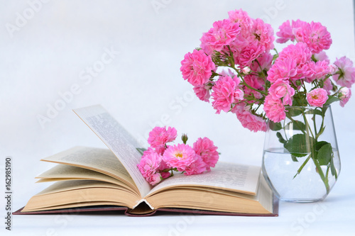 Beautiful flowers lying in the open book. © Александр Колесников