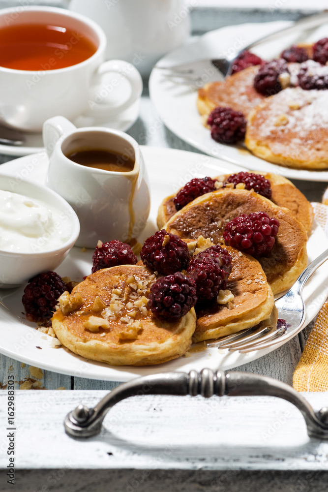 sweet corn pancakes with berries and caramel sauce, vertical
