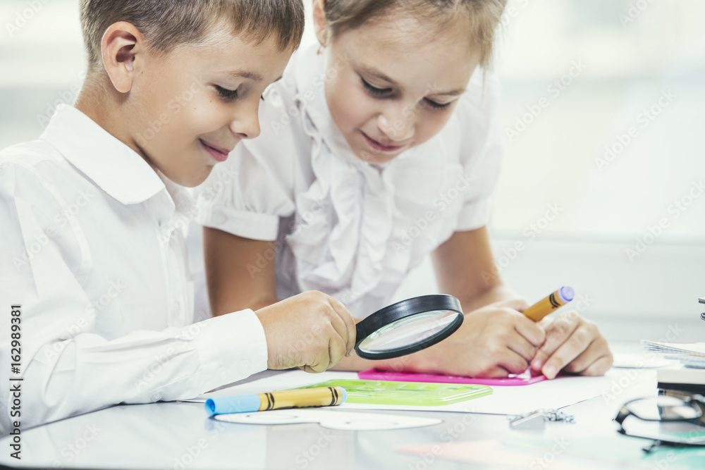 Beautiful children are students together in a classroom at the school receive education happy