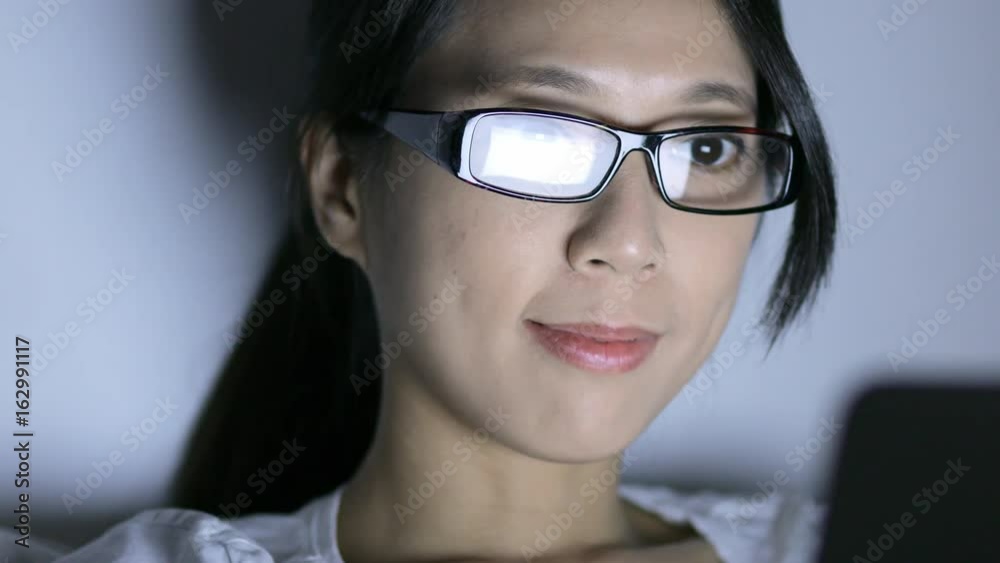 Woman watching on the screen of laptop computer at night Woman watching on the screen of laptop computer at night