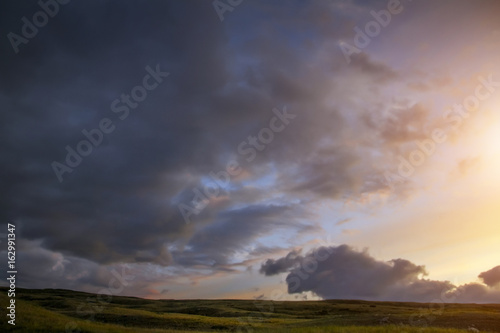 Sunset in the steppe, a beautiful evening sky with clouds, plato Ukok, no one around, Altai, Siberia, Russia