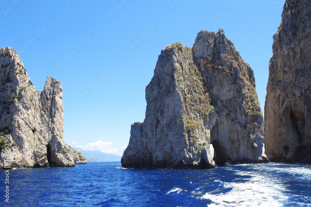 Three famous giant rocks Faraglioni near Capri island, Italy