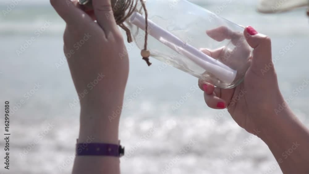 High quality video of looking at message in the bottle on the beach in real 1080p slow motion 250fps.  More videos from this series in my portfolio