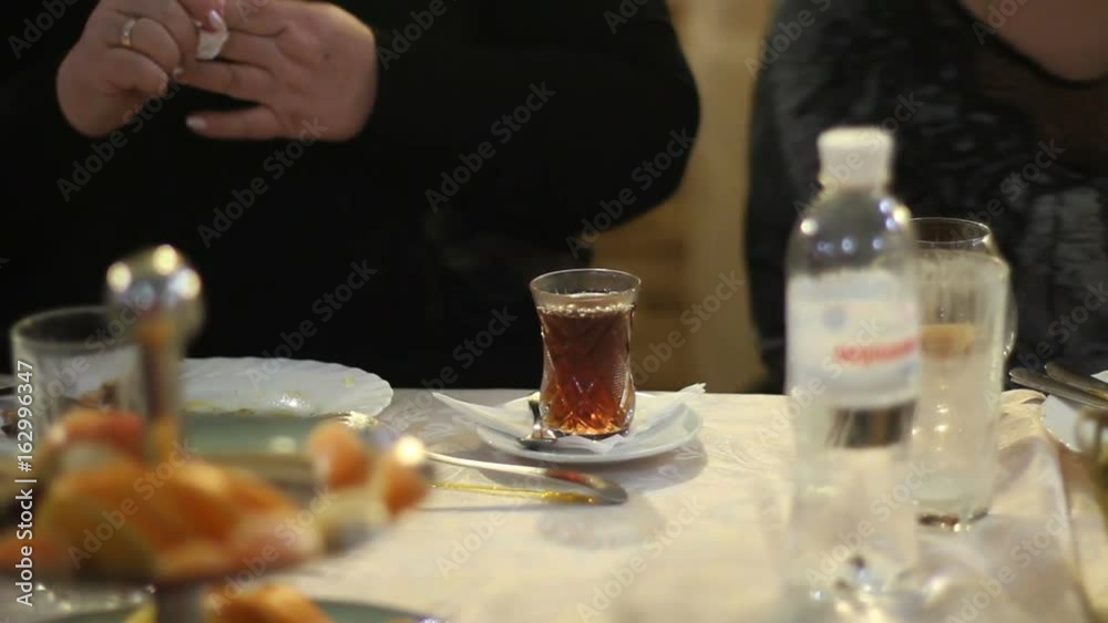 Waitress pour the tea in the glass Waitress pour the tea in the glass
