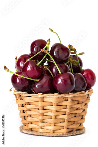 Full basket of red cherries on a stem close up photo