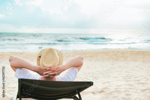 Summer day. Young man lifestyle relaxing with sea view. photo