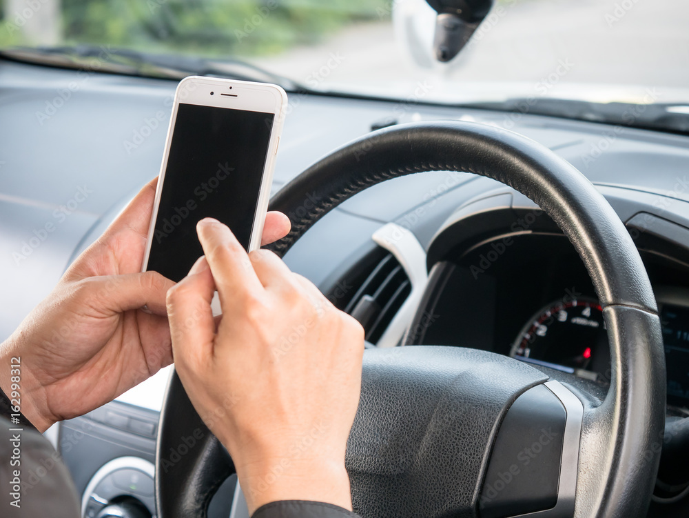 Man uses a phone in a car