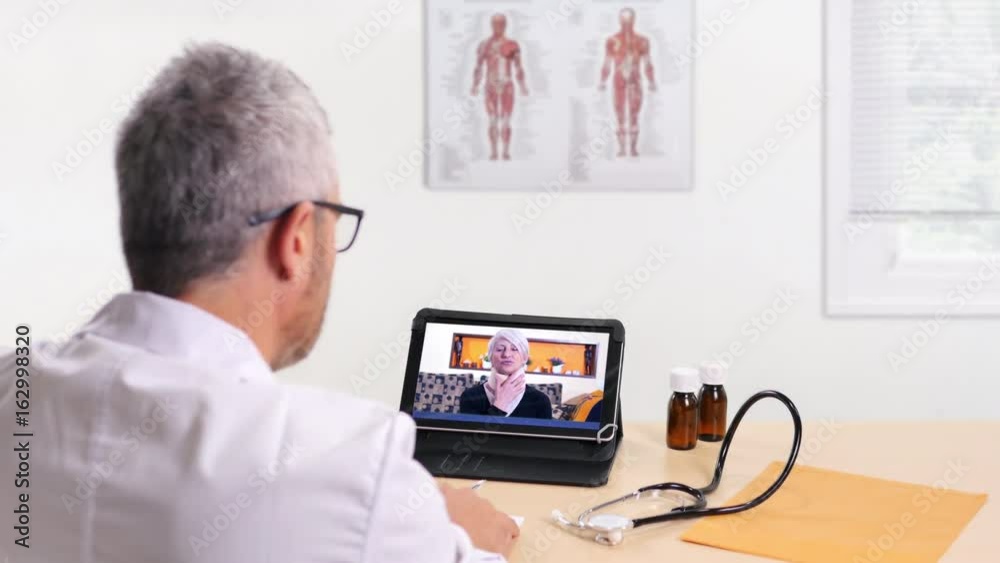 doctor writing medical prescription to a patient online video chatting on tablet doctor writing medical prescription to a patient online video chatting on tablet