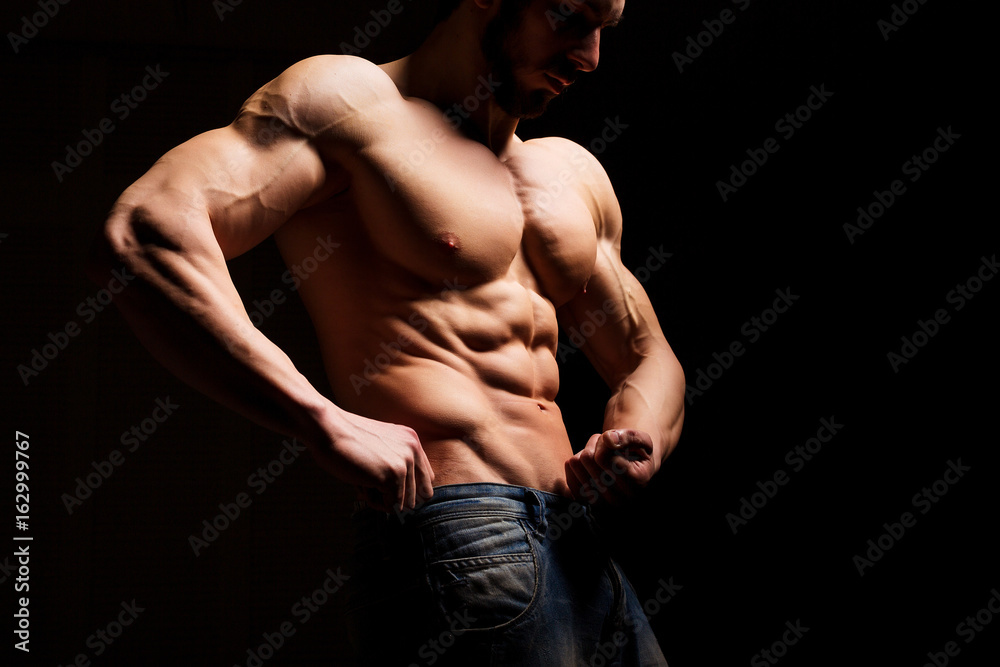 Fitness concept. Muscular and sexy torso of young man having perfect abs, bicep and chest. Male hunk with athletic body. Fitness concept. Muscular and sexy torso of young man having perfect abs, bicep and chest. Male hunk with athletic body.
