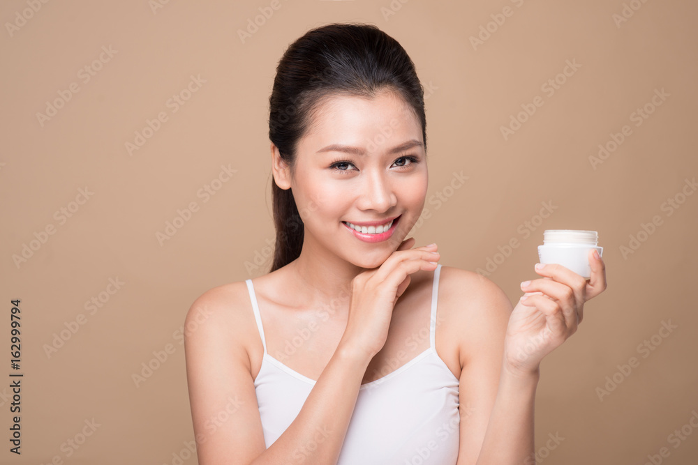 Skincare. Beautiful asian woman show moisturizer or lotion product. Skincare. Beautiful asian woman show moisturizer or lotion product.