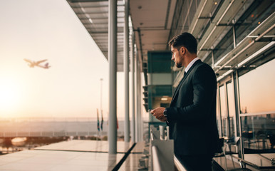 Businessman at airport at sunset