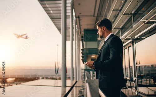 Businessman at airport at sunset