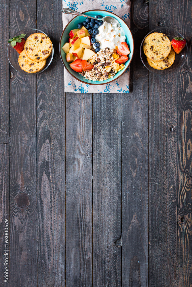 Healthy breakfast, cereal with yogurt, strawberries, blueberry, apple, banana, on rustic wooden. Top view Healthy breakfast, cereal with yogurt, strawberries, blueberry, apple, banana, on rustic wooden. Top view