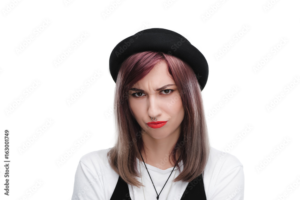 young offended girl in black hat looking at camera, isolated on white young offended girl in black hat looking at camera, isolated on white