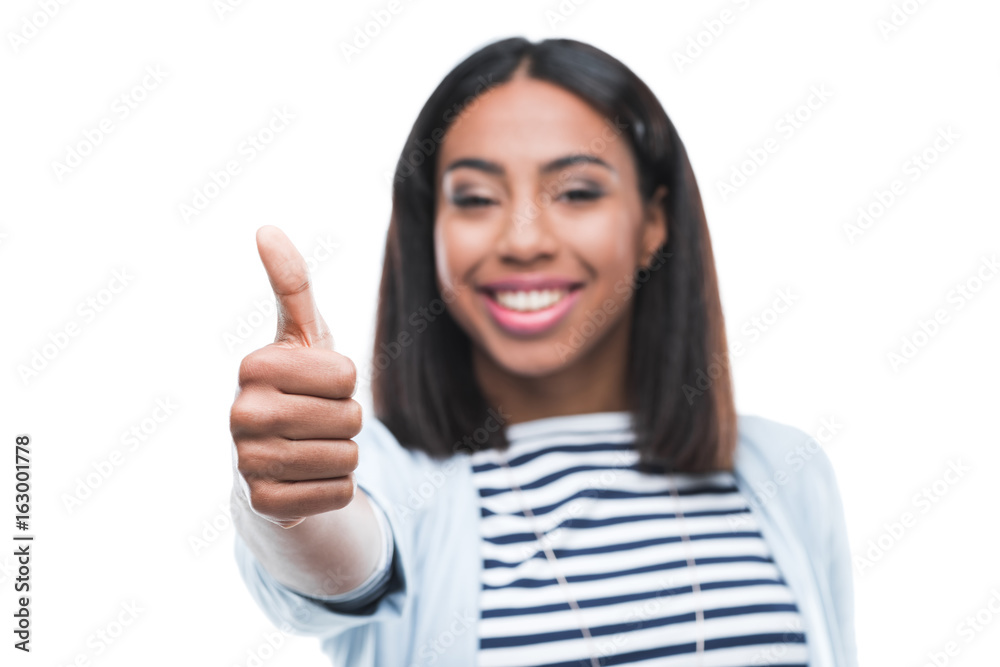 Young african american woman showing thumb up and smiling at camera Young african american woman showing thumb up and smiling at camera