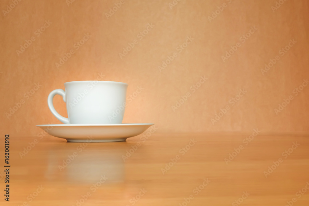 Fototapeta premium A white cup of coffee on wood background.