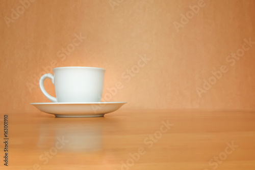 A white cup of coffee on wood background. © zaieiunewborn59