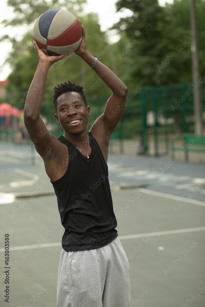 African american man plays on basketball court. Real and authentic activity.