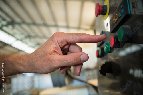 Hand pressing a control button