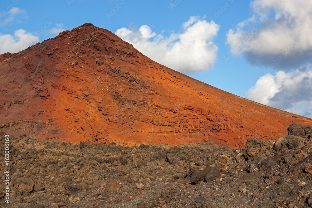 Majestic red volcanic terrain on the blue sky background in the Timanfaya national park on Lanzarote island, Canary Islands, Spain