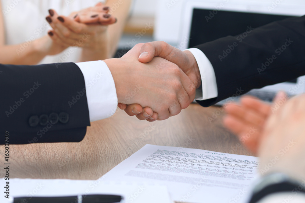 Close up of business people shaking hands at meeting or negotiation in the office. Partners are satisfied because signing contract Close up of business people shaking hands at meeting or negotiation in the office. Partners are satisfied because signing contract