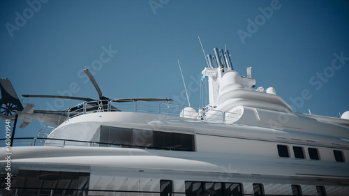 Detail of luxury yacht with a helicopter on the top. © daviles