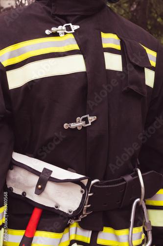 single fireman in fire fighting protection suit and equipment. close up