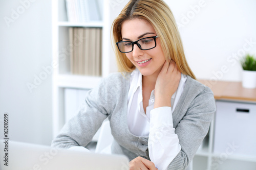 Young business woman or student girl sitting at office workplace with laptop computer. Home business concept