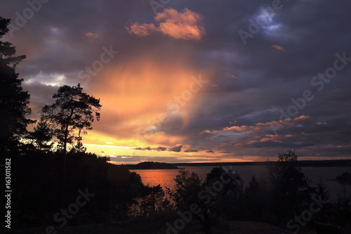 Beautiful summer season specific photograph. Ocean sunset from an island in the archipelago.