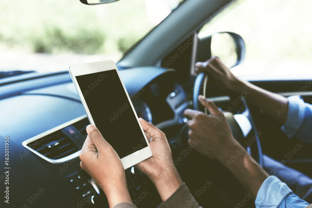 selective focus on hand hold digital tablet blank secreen display inside car