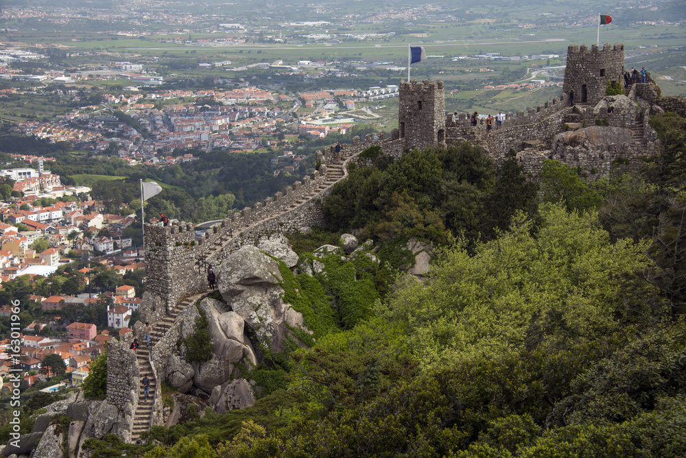 The battlements of the wall of Moorish castle and Sintra city below