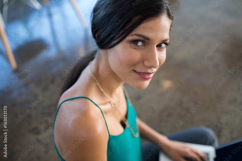 Fotografie Female executive using laptop in office