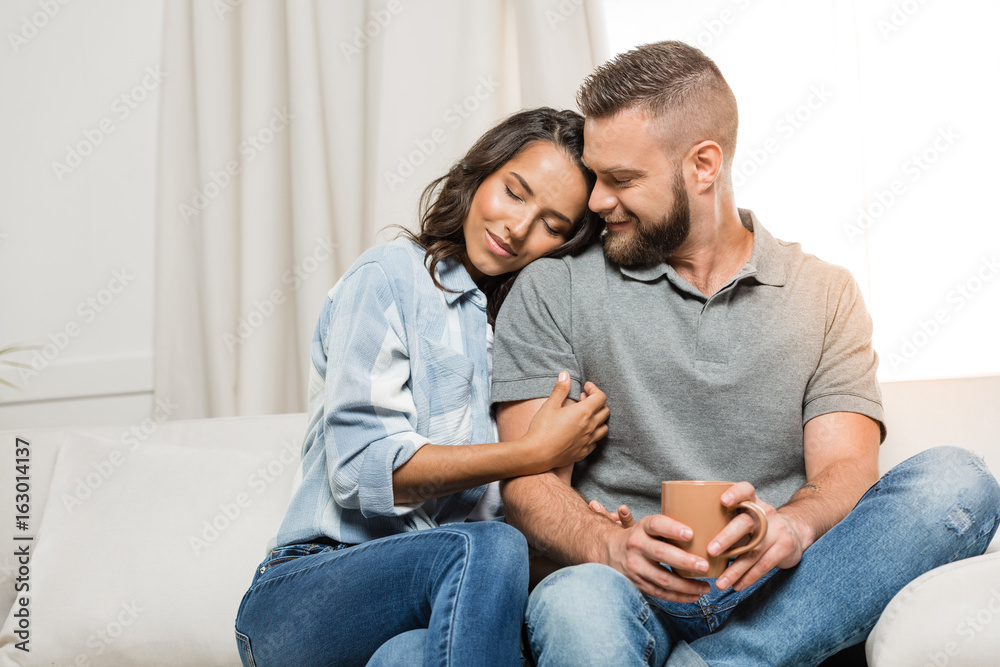 happy tender couple with closed eyes hugging on sofa at home happy tender couple with closed eyes hugging on sofa at home