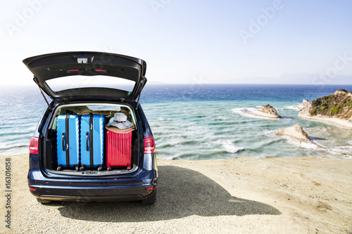summer time and car on beach with landscapeo of cliffs 