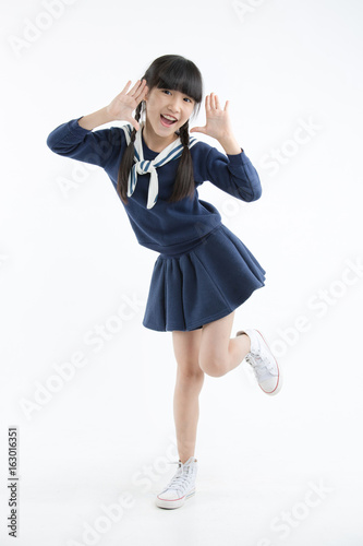 Portrait of Happy little Asian child smiling and dancing isolated on white