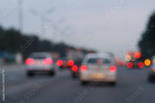 Blurred background with lights of cars at dusk