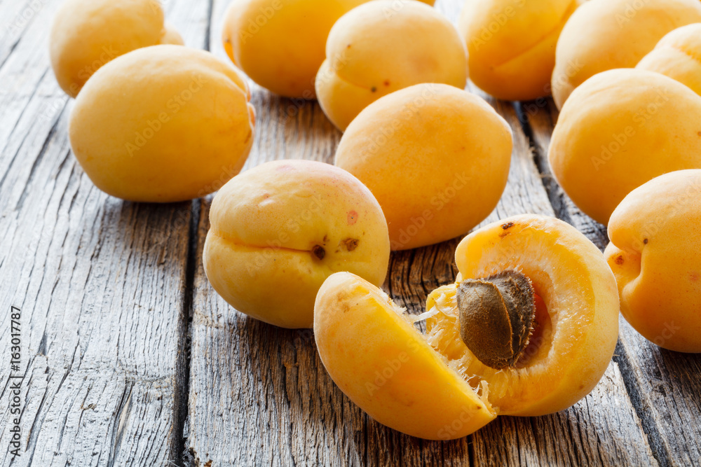 Large ripe sweet delicious apricots on a white plate