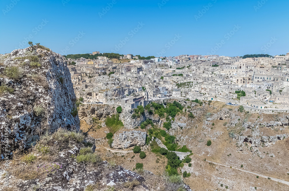 panoramic view of typical stones house (Sassi di Matera) of Matera UNESCO European Capital of Culture 2019 under blue sky. Basilicata