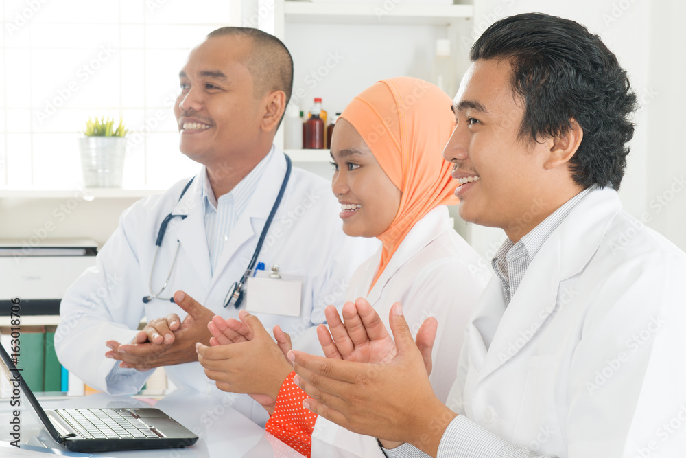 Fototapeta premium Asian doctors clapping hands