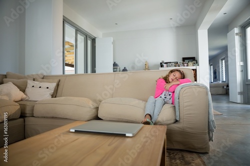Girl sleeping on sofa in the living room
