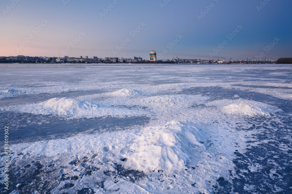 Beautiful winter landscape with frozen river at Dusk Beautiful winter landscape with frozen river at Dusk
