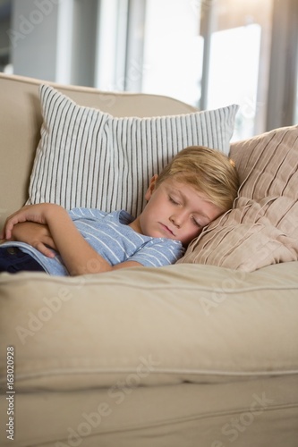 Boy sleeping on sofa in the living room