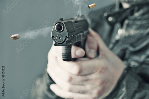 man with hand gun pistol rubber attack violence