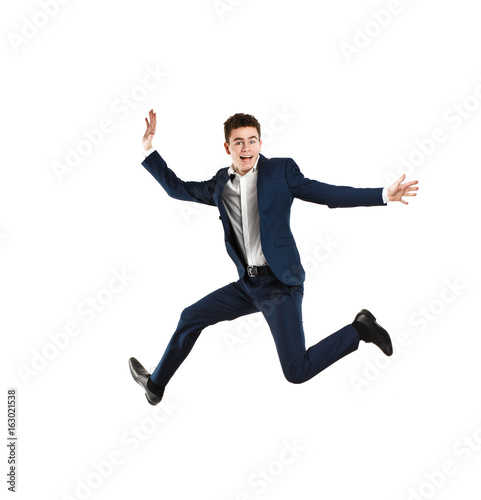 Young man jumping on white background 