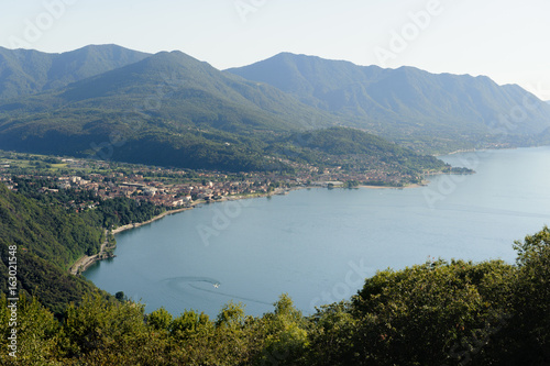Tableau sur toile View from above on Luino and Lago Maggiore with the mountain peaks in the backgr