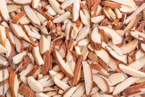 Detail of roasted almond sticks pile, natural source of good fat and protein.