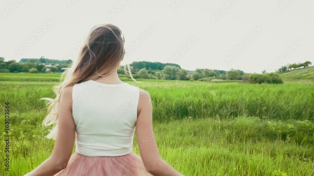 Young woman swinging her bautiful hair on the summer meadow slow motion Young woman swinging her bautiful hair on the summer meadow slow motion