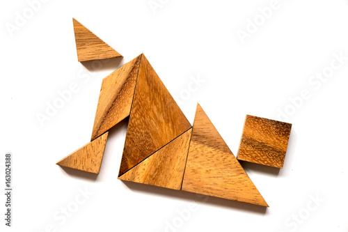 Wooden tangram puzzle in falling man shape on white background (Concept of business failure or cirsis) photo